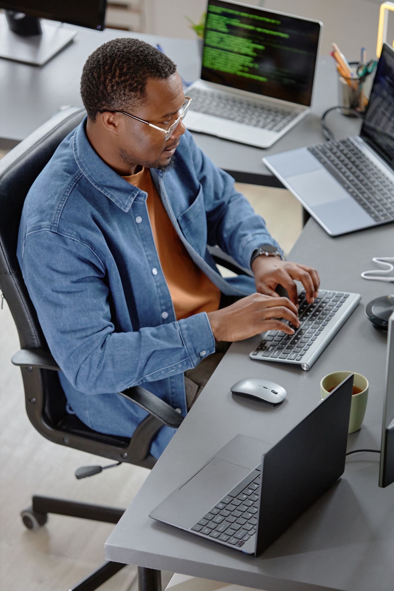 Young Male IT Engineer In Glasses Using Computer