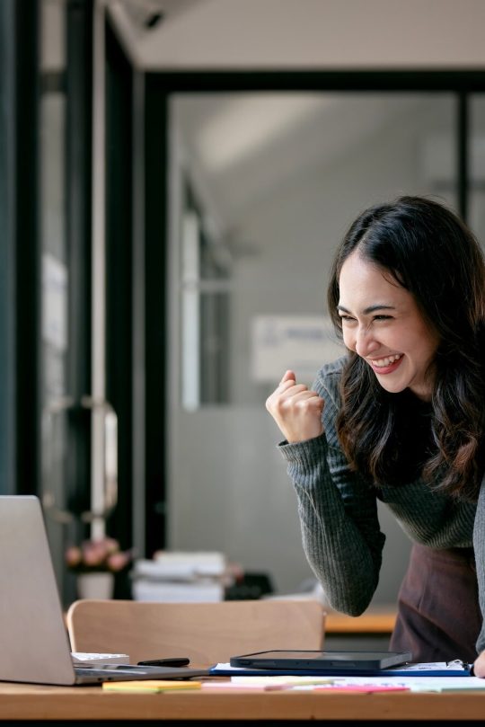 Beautiful Asian woman celebrate with laptop, successful business startup small business concept. Beautiful Asian woman celebrate with laptop, successful business startup small business concept.
